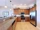 Bright kitchen with stainless steel appliances, granite countertops, and plenty of cabinet storage at 362 Coquina Dr, Tarpon Springs, FL 34689