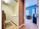 View of the laundry room with white cabinets, utility sink, tile flooring, and access to a carpeted bedroom at 362 Coquina Dr, Tarpon Springs, FL 34689