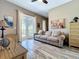 Cozy living room with comfortable seating, neutral decor, and access to outdoor balcony at 362 Coquina Dr, Tarpon Springs, FL 34689