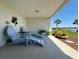 Cozy outdoor patio with charming Adirondack chairs and potted plants, ideal for relaxation with a scenic view at 362 Coquina Dr, Tarpon Springs, FL 34689