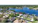 A beautiful lakeside home featuring lush landscaping, a well-manicured lawn, and a charming two-car garage at 3829 Eagleflight Ln, Land O Lakes, FL 34639
