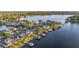 A beautiful view from the sky of a lakeside house surrounded by a well-manicured lawn and private boat docks at 3829 Eagleflight Ln, Land O Lakes, FL 34639