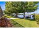 Picturesque backyard with lush greenery, leading to a charming boat dock and serene water views at 3829 Eagleflight Ln, Land O Lakes, FL 34639