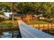 This home features a large waterfront backyard with mature trees and a long dock perfect for enjoying the lake at 3829 Eagleflight Ln, Land O Lakes, FL 34639