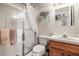 Bathroom with glass shower, vanity, and window with plantation shutters at 3829 Eagleflight Ln, Land O Lakes, FL 34639