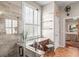 Elegant bathroom featuring natural light, granite counter, and a decorative stool at 3829 Eagleflight Ln, Land O Lakes, FL 34639