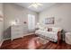 Cozy bedroom with hardwood floors, ceiling fan, and neutral-toned decor at 3829 Eagleflight Ln, Land O Lakes, FL 34639