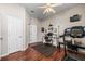 Home gym with wood floors, a ceiling fan, a treadmill and a computer at 3829 Eagleflight Ln, Land O Lakes, FL 34639