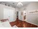 Bedroom with wood floors, fan, closet and entry to bathroom vanity at 3829 Eagleflight Ln, Land O Lakes, FL 34639