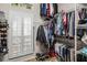 Organized walk-in closet with ample storage space, racks, and a window shutter at 3829 Eagleflight Ln, Land O Lakes, FL 34639