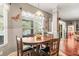 Dining room with a decorative light fixture, wood floors and large windows with blinds at 3829 Eagleflight Ln, Land O Lakes, FL 34639