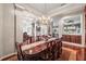 Elegant dining room featuring a large wooden table and chandelier with access to other living areas at 3829 Eagleflight Ln, Land O Lakes, FL 34639