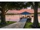 Waterfront home features a private covered dock with boat lift, swing, and seating area, ideal for enjoying the lake at 3829 Eagleflight Ln, Land O Lakes, FL 34639