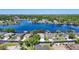 Picture of a beautiful lakeside home featuring lush landscaping, a well-manicured lawn, and a charming two-car garage at 3829 Eagleflight Ln, Land O Lakes, FL 34639