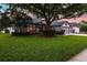 Charming home featuring manicured lawn, lush landscaping, and warm exterior lighting, creating an inviting curb appeal at 3829 Eagleflight Ln, Land O Lakes, FL 34639