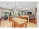 Open kitchen with a granite island, stainless steel dishwasher, and cherry wood cabinets at 3829 Eagleflight Ln, Land O Lakes, FL 34639