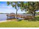 Scenic lake view with a wooden pier and gazebo, perfect for relaxing and enjoying the waterfront at 3829 Eagleflight Ln, Land O Lakes, FL 34639