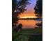 Picturesque lake view with a dock swing at sunset, creating a tranquil ambiance at 3829 Eagleflight Ln, Land O Lakes, FL 34639