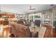 Spacious living room featuring a lake view, a ceiling fan and beautiful hardwood floors at 3829 Eagleflight Ln, Land O Lakes, FL 34639