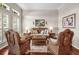 Cozy living room with wicker furniture and shuttered windows offers a relaxing space at 3829 Eagleflight Ln, Land O Lakes, FL 34639