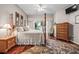 Large main bedroom offers access to lanai, ceiling fan, and hardwood floors at 3829 Eagleflight Ln, Land O Lakes, FL 34639