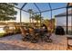 Screened patio featuring an outdoor dining set with seating for six overlooking the water at 3829 Eagleflight Ln, Land O Lakes, FL 34639