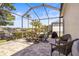 Large screened patio featuring outdoor dining and seating areas, ideal for enjoying the serene lakeside setting at 3829 Eagleflight Ln, Land O Lakes, FL 34639