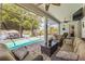 Relaxing patio with a pool and an outdoor living area overlooking the scenic lake at 3829 Eagleflight Ln, Land O Lakes, FL 34639