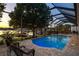 The screened-in pool and patio area provide beautiful lake views that enhance the home's outdoor living space at 3829 Eagleflight Ln, Land O Lakes, FL 34639