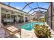 Relaxing screened pool and patio area with comfortable seating, creating a perfect outdoor entertainment space at 3829 Eagleflight Ln, Land O Lakes, FL 34639