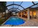 A screened-in outdoor pool with patio area extends the living space with ample seating and entertainment areas at 3829 Eagleflight Ln, Land O Lakes, FL 34639