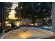 The screened-in pool and jacuzzi overlook the lake, and a covered dock area enhances this home's appeal at 3829 Eagleflight Ln, Land O Lakes, FL 34639