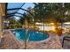 Enclosed pool area with waterfront views, a pool and lounge chairs, perfect for relaxation at 3829 Eagleflight Ln, Land O Lakes, FL 34639