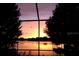 Beautiful sunset view of the lake, viewed from the lanai, highlighting waterfront living and outdoor enjoyment at 3829 Eagleflight Ln, Land O Lakes, FL 34639