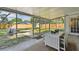 Screened patio with outdoor seating area and a view of the expansive backyard and a shed beyond at 4007 W Bay Villa Ave, Tampa, FL 33611