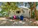 Back exterior view of this gray home with a small yard and several bikes in the back at 412 E Columbus Dr, Tampa, FL 33602