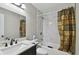 Well-lit bathroom featuring a vanity, a mirror and a shower with modern marble tile at 412 E Columbus Dr, Tampa, FL 33602