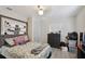 Cozy bedroom features light gray flooring, a comfortable bed, and ample storage with a dresser and overhead shelving at 412 E Columbus Dr, Tampa, FL 33602