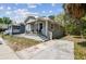 Charming bungalow-style home with gray siding and a welcoming front porch at 412 E Columbus Dr, Tampa, FL 33602