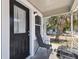Covered porch area with view of the home's exterior, a grill, and chair at 412 E Columbus Dr, Tampa, FL 33602