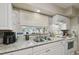 Functional kitchen with granite countertops and a stainless steel sink at 412 E Columbus Dr, Tampa, FL 33602