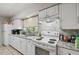 Clean kitchen with white appliances, stone countertops, and plenty of natural light at 412 E Columbus Dr, Tampa, FL 33602