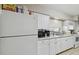 Bright kitchen with white cabinets, stone countertops, and stainless steel appliances at 412 E Columbus Dr, Tampa, FL 33602