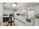 Spacious kitchen featuring white cabinets, granite countertops, and an adjacent dining area at 412 E Columbus Dr, Tampa, FL 33602