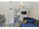 Open living room with modern ceiling fan, TV and neutral wall and floor coloring at 412 E Columbus Dr, Tampa, FL 33602