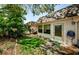Charming backyard with lush greenery, a stone path, and a tranquil outdoor space for relaxing and entertaining at 4242 Sheldon Pl, New Port Richey, FL 34652