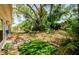 Private backyard oasis, complete with mature landscaping and stone pavers, offering a peaceful outdoor retreat at 4242 Sheldon Pl, New Port Richey, FL 34652