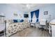 Bedroom featuring a daybed, workspace, wood floors, and blue accent wall at 4242 Sheldon Pl, New Port Richey, FL 34652