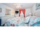 Bedroom featuring wicker furniture, coral curtains, and a seashell-themed comforter at 4242 Sheldon Pl, New Port Richey, FL 34652