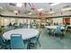 The community's dining room provides abundant table seating in a well-lit and inviting space at 4242 Sheldon Pl, New Port Richey, FL 34652